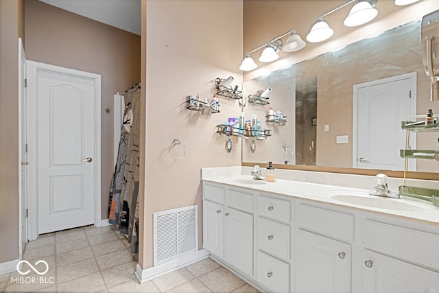 full bath with double vanity, tile patterned flooring, visible vents, and a sink