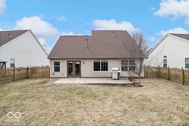 rear view of house featuring a yard, a fenced backyard, a patio, and roof with shingles