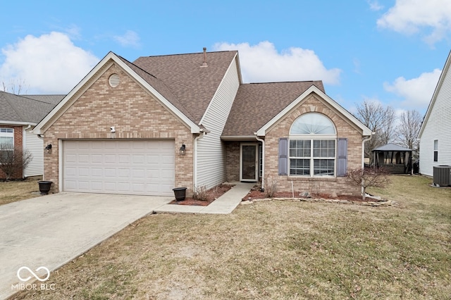 ranch-style house featuring brick siding, roof with shingles, concrete driveway, an attached garage, and a front yard