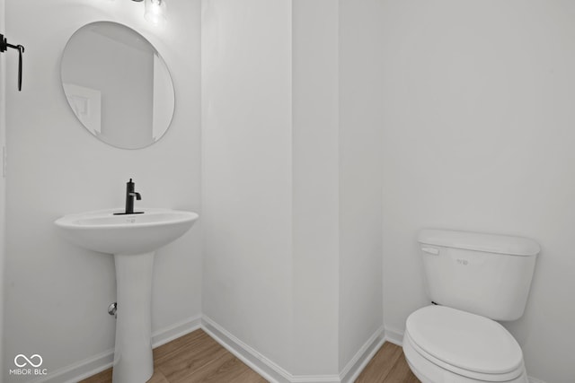 5119 Rolling Meadow Blvd, Indianapolis, IN 46237 - bathroom with baseboards, wood finished floors, and toilet