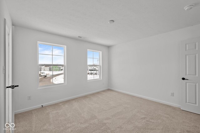 5119 Rolling Meadow Blvd, Indianapolis, IN 46237 - unfurnished room with carpet flooring, a textured ceiling, baseboards, and visible vents