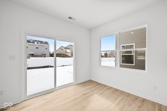 5119 Rolling Meadow Blvd, Indianapolis, IN 46237 - unfurnished room featuring baseboards, visible vents, light wood-type flooring, and a healthy amount of sunlight