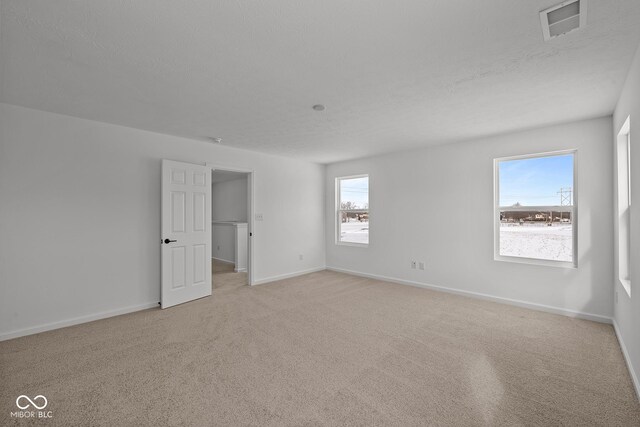 5119 Rolling Meadow Blvd, Indianapolis, IN 46237 - empty room featuring light carpet, a textured ceiling, baseboards, and visible vents