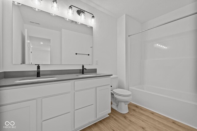 5119 Rolling Meadow Blvd, Indianapolis, IN 46237 - full bath featuring visible vents, a sink, toilet, and wood finished floors