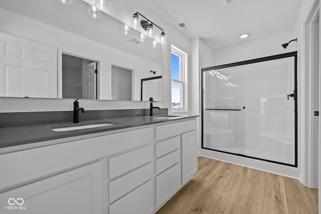 5119 Rolling Meadow Blvd, Indianapolis, IN 46237 - full bathroom with wood finished floors, a sink, a stall shower, and visible vents