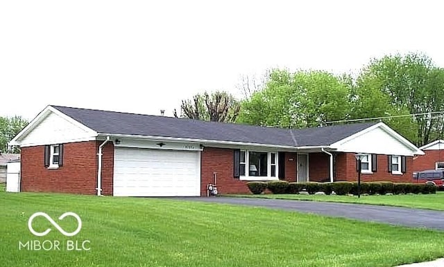 single story home featuring a garage and a front yard