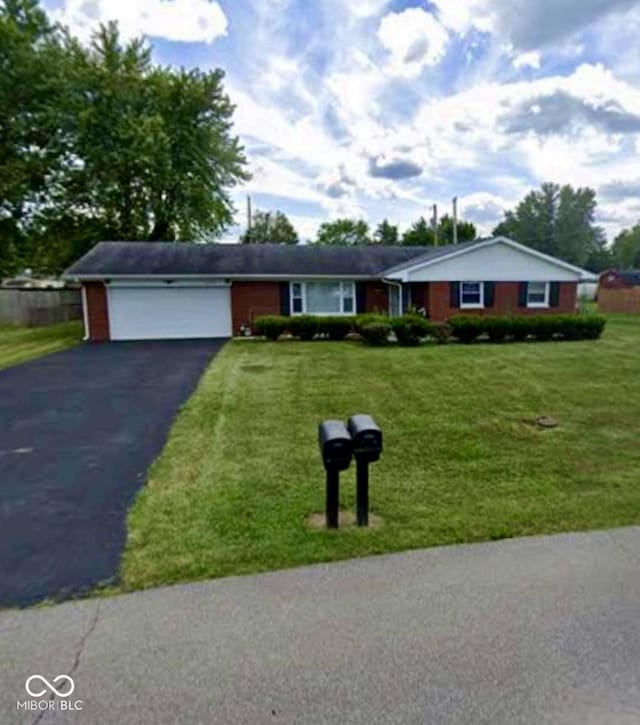 single story home featuring a front yard and a garage