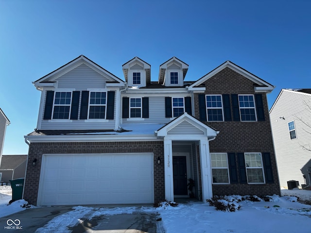 view of front of property with an attached garage and brick siding