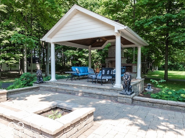 view of patio / terrace featuring a gazebo and an outdoor living space with a fireplace