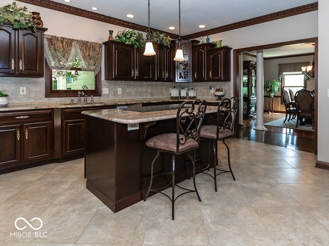 kitchen featuring a center island, a sink, and dark brown cabinetry