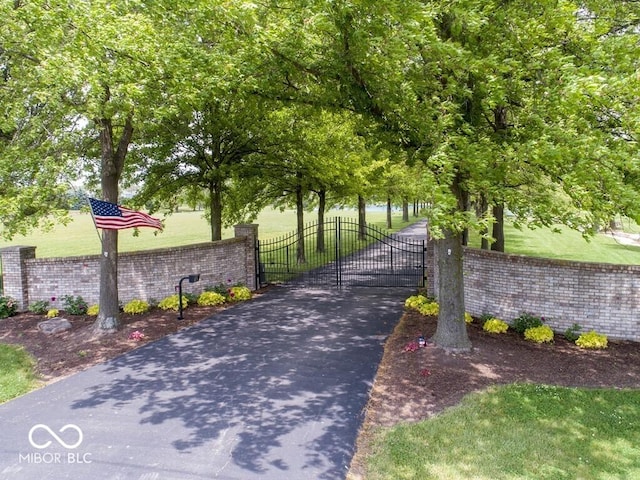 exterior space with a gate and a lawn