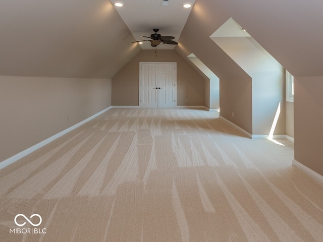 bonus room featuring light carpet, baseboards, vaulted ceiling, and a ceiling fan