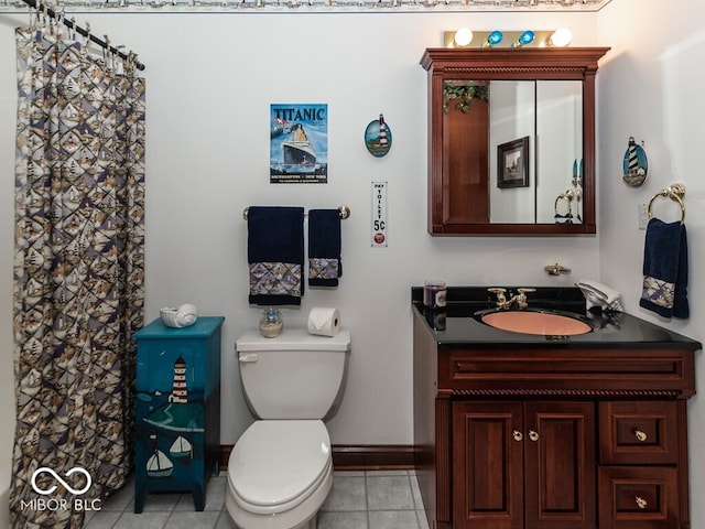 full bath with toilet, tile patterned flooring, baseboards, and vanity