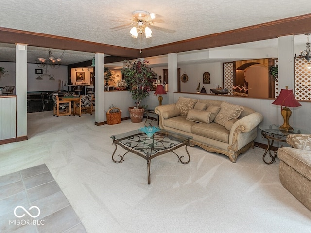 living area with ceiling fan, a textured ceiling, and carpet flooring