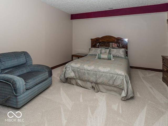 bedroom with light colored carpet, a textured ceiling, and baseboards