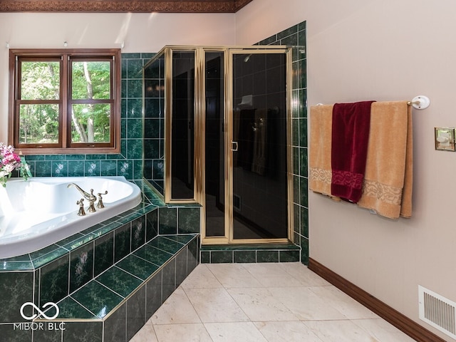 full bath with visible vents, a stall shower, a bath, baseboards, and tile patterned floors