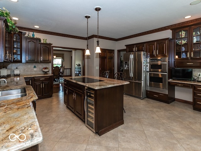 kitchen featuring a sink, dark brown cabinets, appliances with stainless steel finishes, a center island, and glass insert cabinets