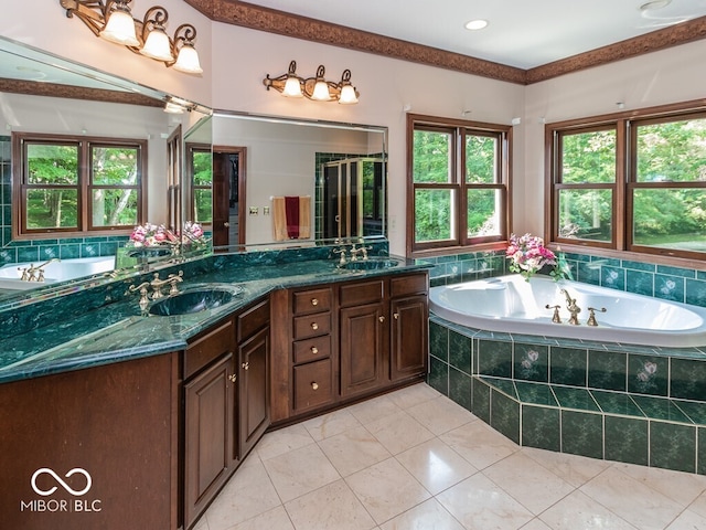 bathroom with a garden tub, double vanity, tile patterned flooring, and a sink