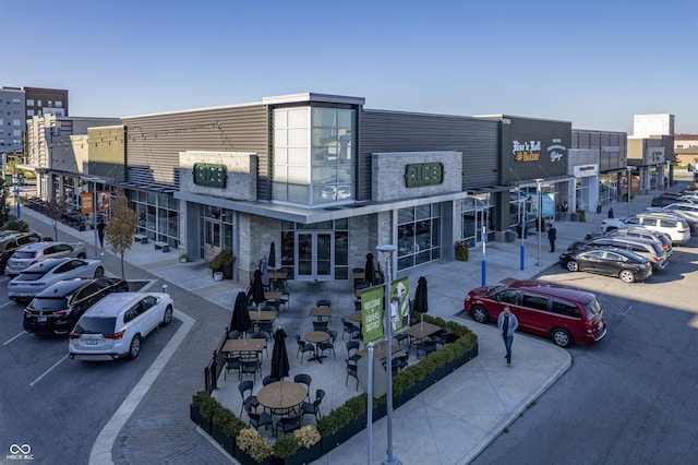 view of property featuring uncovered parking and a city view