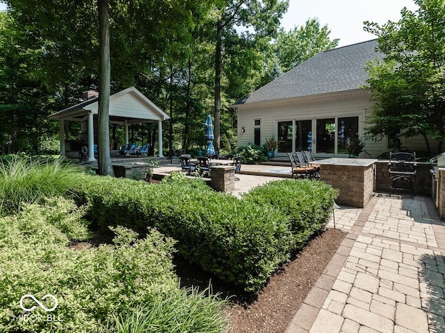 exterior space featuring a patio, an outdoor kitchen, and a gazebo