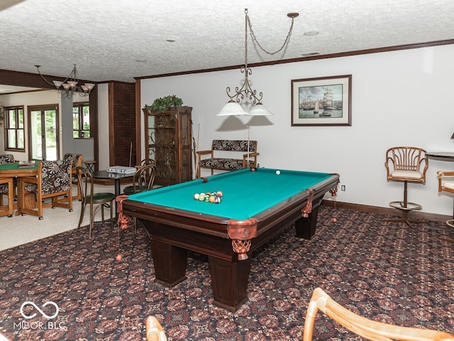 playroom featuring a textured ceiling, ornamental molding, and carpet