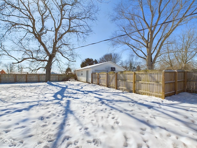 snowy yard with fence