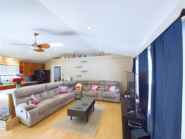 living room with lofted ceiling, ceiling fan, light wood-style flooring, and recessed lighting