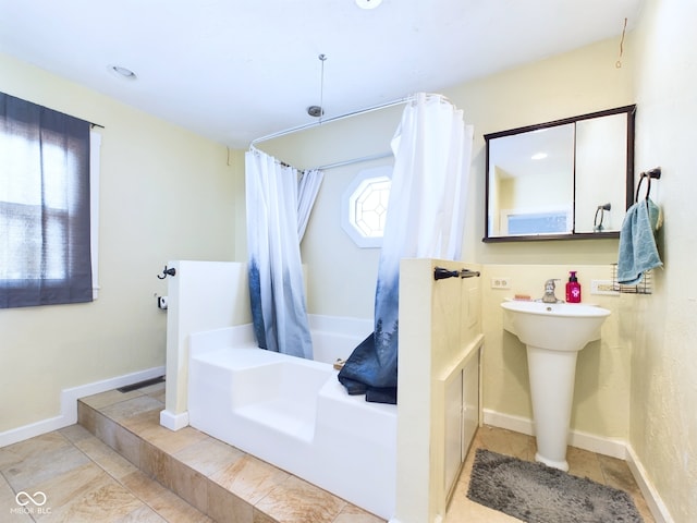 full bath with baseboards and shower / tub combo with curtain