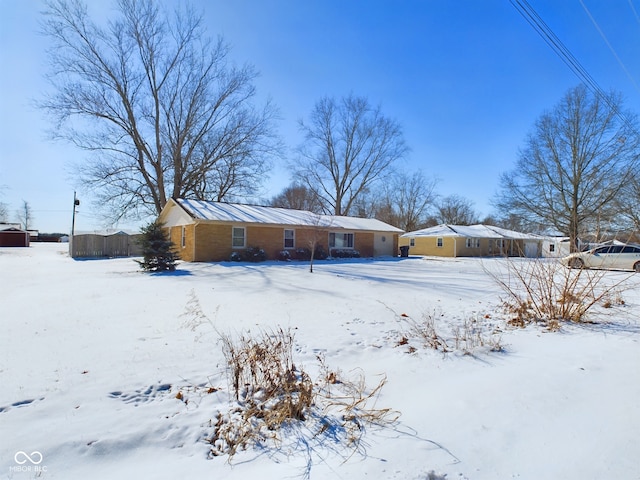 view of snow covered back of property