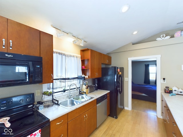 kitchen with vaulted ceiling, light countertops, black appliances, open shelves, and a sink