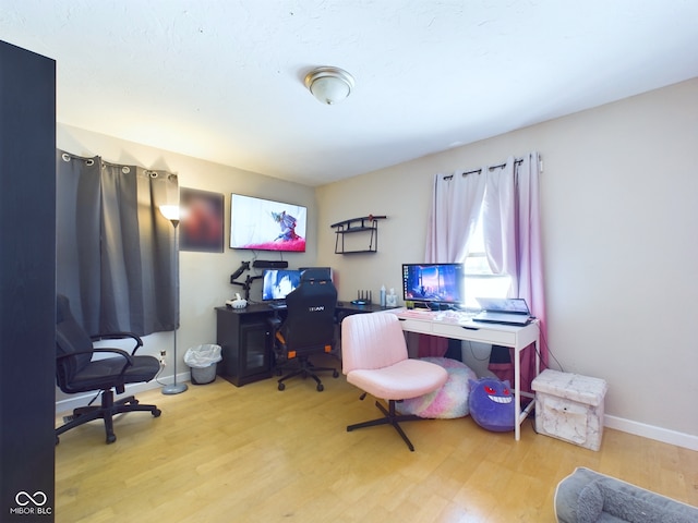 office space with light wood-style flooring and baseboards