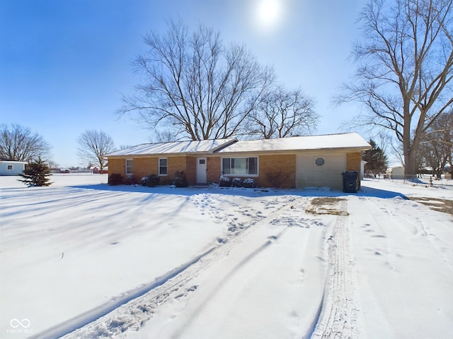 view of front of property with a garage and brick siding