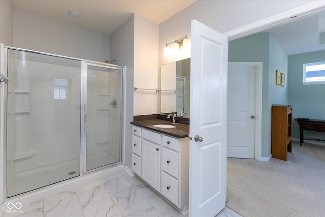 full bath with a stall shower, marble finish floor, vanity, and baseboards