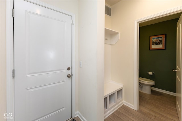 mudroom featuring baseboards, visible vents, and light wood finished floors