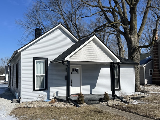 bungalow-style house featuring a chimney