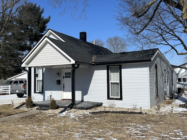 view of front of house with a porch and a chimney