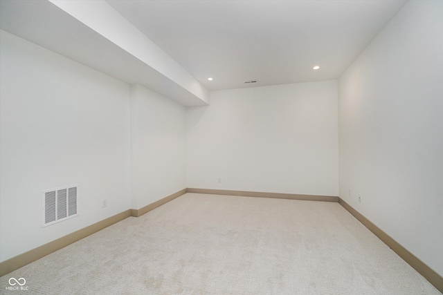 interior space with light colored carpet, visible vents, baseboards, and recessed lighting