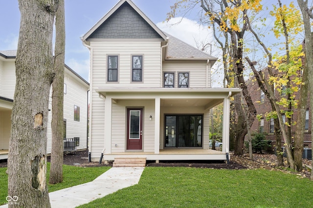 view of front facade with a front yard and covered porch