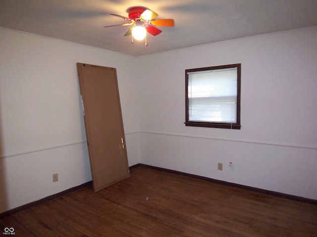 empty room with dark wood-type flooring, ceiling fan, and baseboards