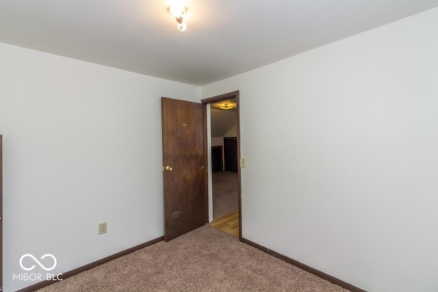 carpeted empty room with baseboards