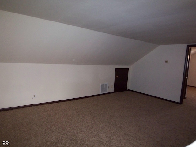 bonus room with baseboards, visible vents, vaulted ceiling, and carpet flooring