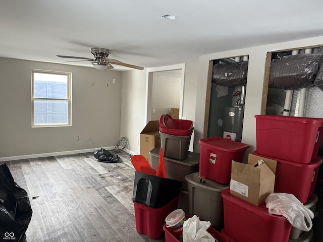 interior space with water heater, ceiling fan, and hardwood / wood-style flooring