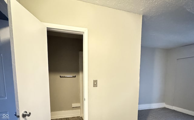 interior space featuring baseboards and a textured ceiling