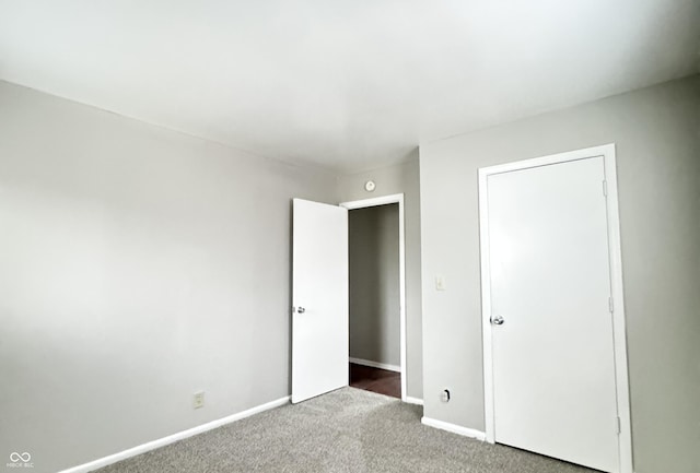 unfurnished bedroom featuring baseboards and carpet flooring