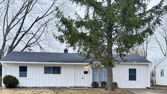 view of front of home with a chimney and board and batten siding