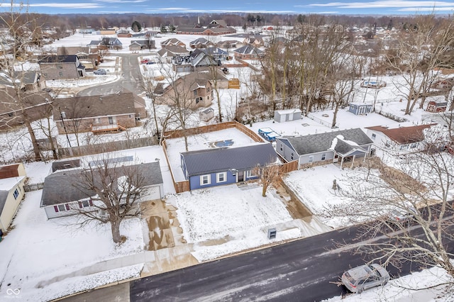 snowy aerial view featuring a residential view