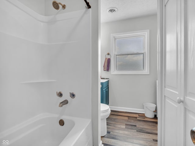 full bathroom with shower / bath combination, visible vents, wood finished floors, a textured ceiling, and vanity