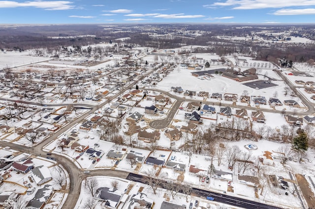 snowy aerial view featuring a residential view