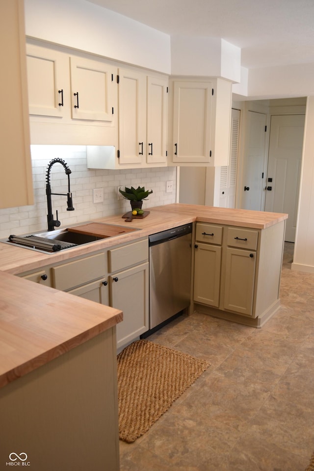 kitchen featuring kitchen peninsula, sink, tasteful backsplash, dishwasher, and wood counters