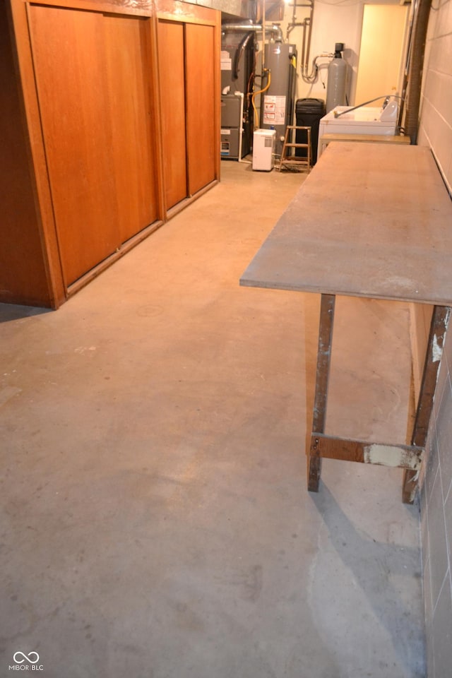 basement featuring washer / clothes dryer and water heater